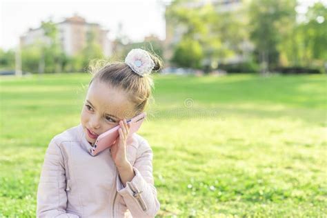 Girl Looking Away Talking On Phone In The Park Stock Image Image Of