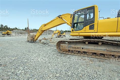 Three Excavators Parked On A New Road Construction Site Stock Photo