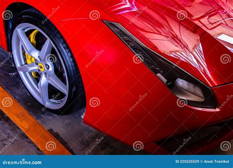 Close Up Of Headlights Wheel And Rim Of Red Metallic Ferrari Car