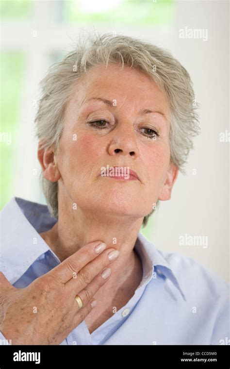 Older Female Person Touching Her Throat Stock Photo Alamy