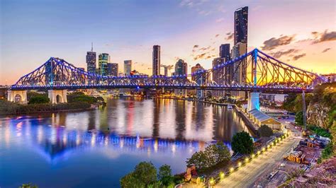 Download A Mesmerising Sunset Over Brisbane City Skyscrapers Wallpaper