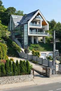 A House On A Slope Connects To Its Surroundings Through A Glass Elevator