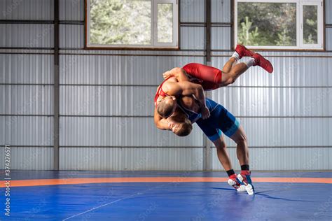 Two Men In Sports Wrestling Tights And Wrestling During A Traditional