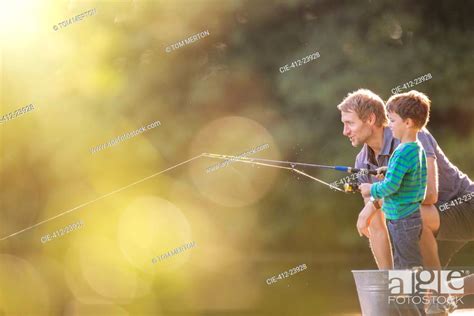 Father And Son Fishing In Lake Stock Photo Picture And Royalty Free
