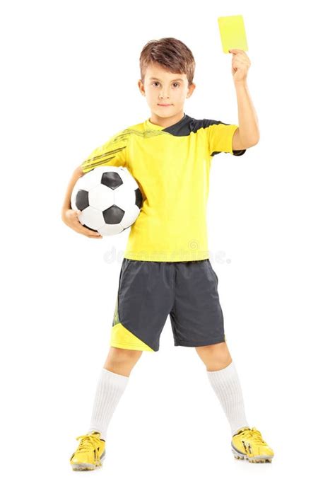 Kid In Sportswear Holding Soccer Ball And Yellow Card Stock Photo