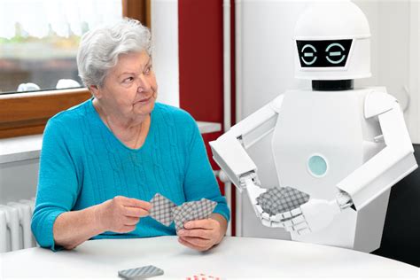 Ambient Assisted Living Service Robot Is Playing A Card Game With A Senior Adult Woman