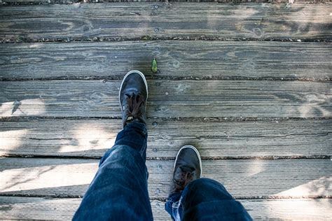 Free Stock Photo of Walking Human Legs On Wooden Boardwalk