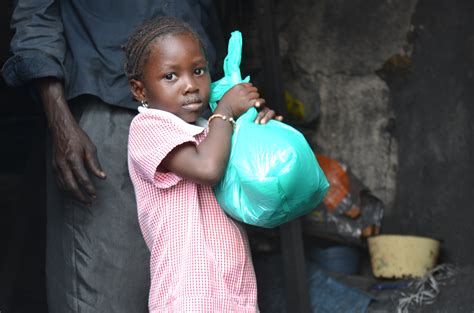 Girl Buying Charcoal In The Adjamé Neighgourhood Of Côte Divoires