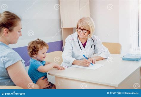 Friendly Doctor Pediatrician With Patient Child At Clinic Stock Photo
