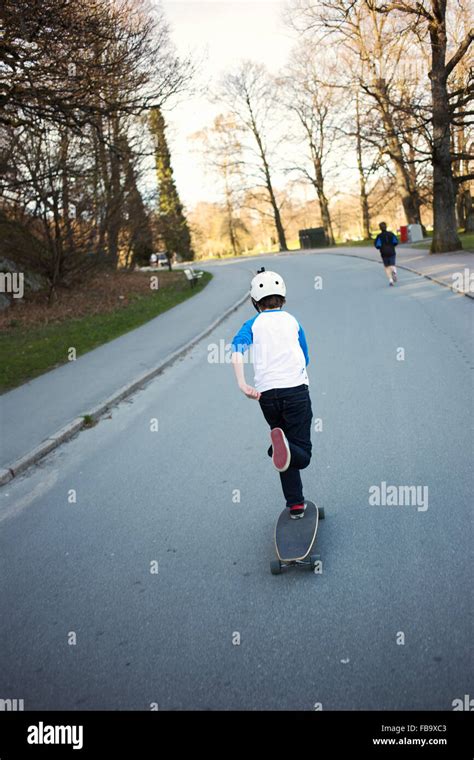 Sweden Gothenburg Slottsskogen Rear View Of Boy 12 13 Riding