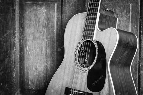 Free Photo Beautiful Grayscale Shot Of An Acoustic Guitar Leaned On A