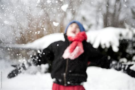 Boy Joyously Throws Snow Into The Air By Stocksy Contributor Cara