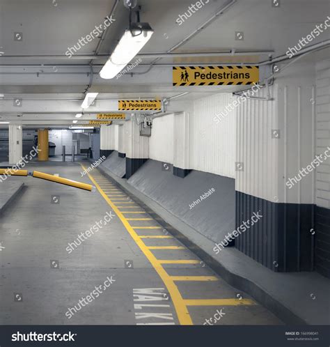 Pedestrian Walkway And Signage In An Undercover Parking Garage. Stock