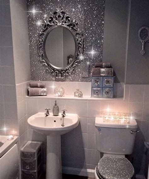 A Bathroom Decorated In Silver And White With Sparkles On The Mirror
