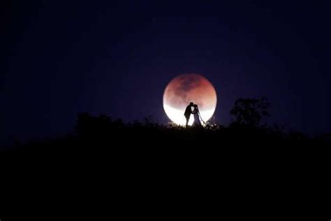 A Couple Poses For Photo During A Total Lunar Eclipse From In Brasilia