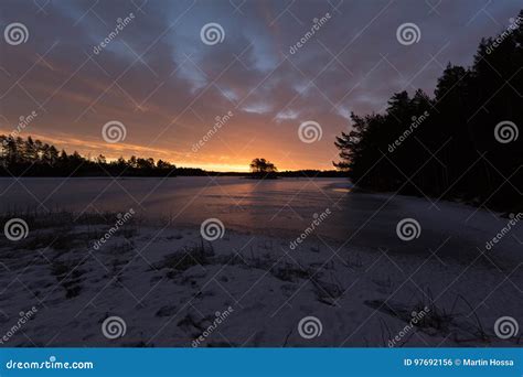 Colorful Sunrise With Clouds In The Sky And Frozen Lake Stock Photo