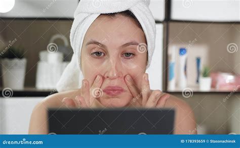 Facial Skin Massage Attractive Girl In Bathroom With Towel And Mirror Does Facial Massage In