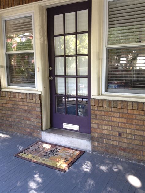 Purple front door. Chambord by Benjamin Moore. Boston Terrier in window