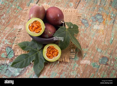 Fruits Of Gulupa On Vine Wood Table Passiflora Pinnatistipula Stock