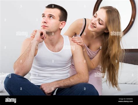Young Russian Wife Warmly Comforting Upset Husband In Bedroom Stock