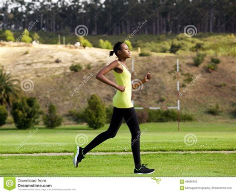 Fit Young African American Woman Jogging Outdoors In A
