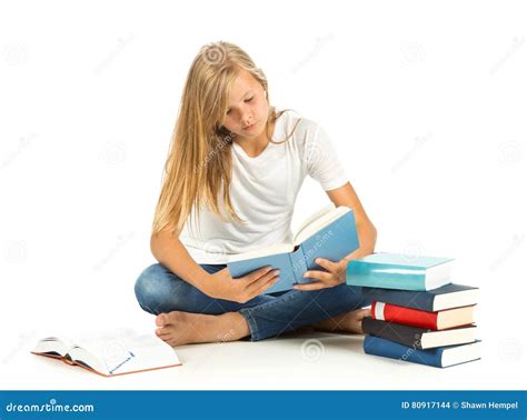 Young Girl Sitting On The Floor Reading Over White Background Stock
