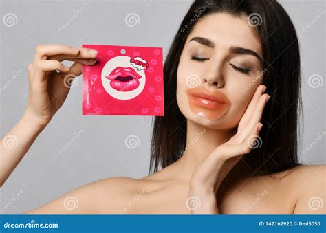 Young Beautiful Woman With Cosmetic Patch For Lips And Skin And With Closed With Pleasure Eyes