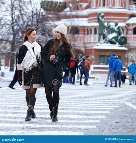 Two Girls Tourists Are Photographed In Moscow Russia Stock Photo
