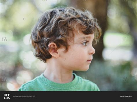 Profile Of Wavy Haired Boy In Rural Setting Stock Photo