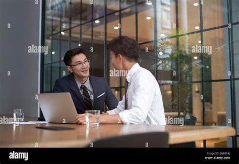 Successful Chinese Businessmen Talking In Office Stock Photo Alamy