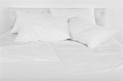 Premium Photo White Pillows On Bed Close Up
