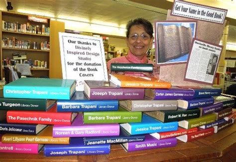 Morinville Public Library Employee Najma Cole Looks Over The Many Book