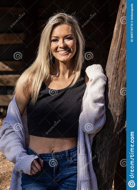 A Lovely Blonde Model In Western Gear Poses Outdoor While Enjoying The Spring Weather Stock