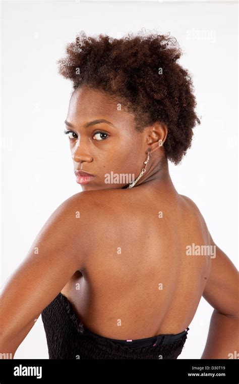 lovely black woman looking over her shoulder with a thoughtful and serious expression stock