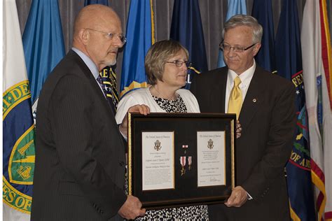 National Intelligence Director James R Clapper Left Presents The National Intelligence Medal