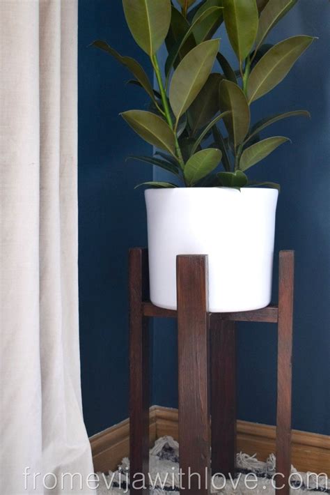 A Potted Plant Sitting On Top Of A Wooden Stand