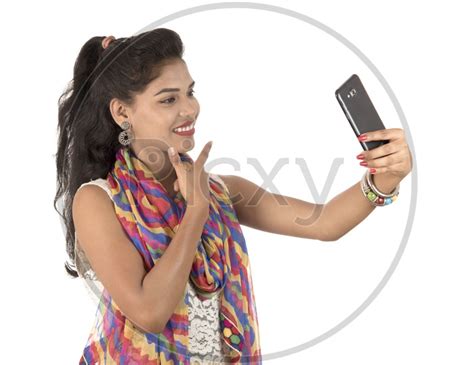 Image Of A Happy Young Indian Girl Taking Selfie With Smart Phone And