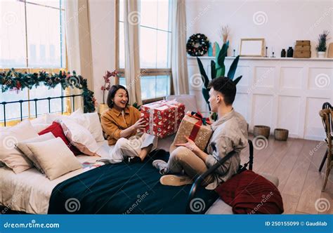 Girl And Man Giving Ts To Each Other On Bed Stock Image Image Of