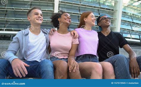 Multi Racial Group Young People Hugging Sitting Outdoors Friendship