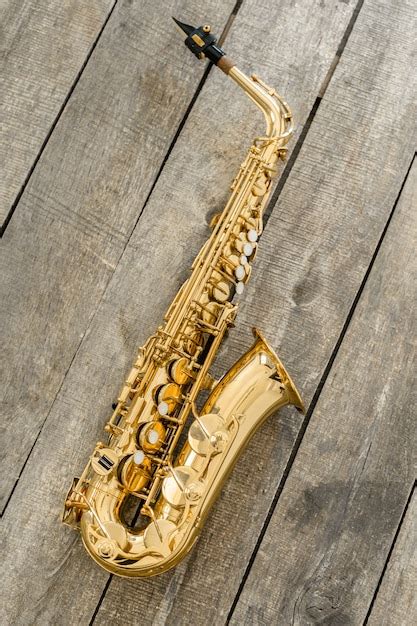 Premium Photo Beautiful Golden Saxophone On Wooden Background