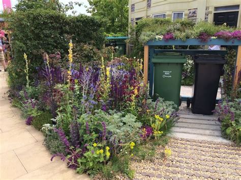 If you have unused space at the side of your house, look into housing your bins there and installing a carefully positioned screen to keep them hidden. Nigel Dunnett Barbican - a bin store with green roof. A ...