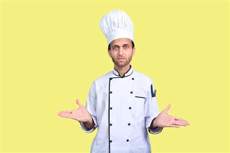 Premium Photo Handsome Chef Cook White Outfit Over Yellow Background Indian Pakistani Model