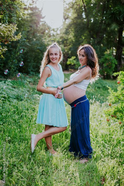 Pregnant Mother And Daughter Happy In The Field Stock Photo Adobe Stock