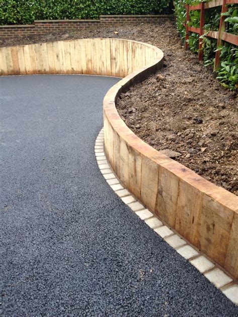 Curved Sleeper Walls For Drive Entrance Front Yard Landscaping