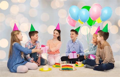 Happy Children Giving Presents At Birthday Party Stock Photo Image Of