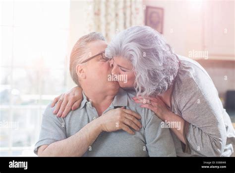 Affectionate Mature Adult Couple Kissing At Home Stock Photo Alamy