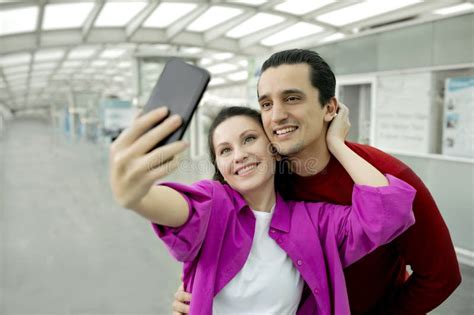 Happy Tourists Couple Making Selfie On Mobile Phone In Airport Stock
