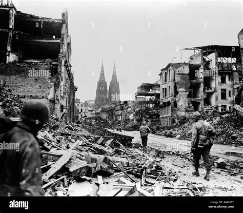 1940s American Soldiers Walking In Ruins Of Cologne Germany Stock Photo
