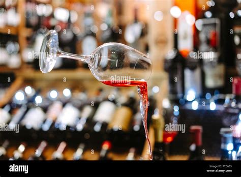 Glass Of Wine Falling Mid Air With Spill Stock Photo Alamy