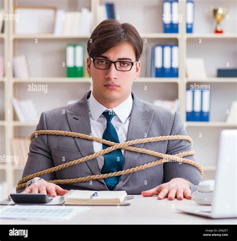 The Businessman Tied Up With Rope In Office Stock Photo Alamy